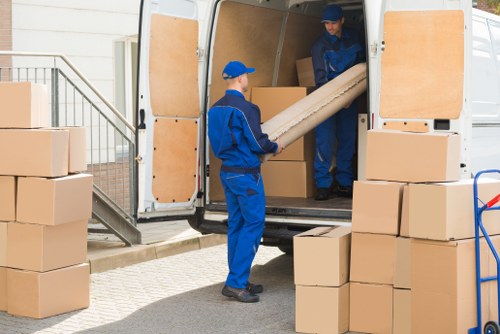 Removal team loading boxes for a Hammersmith flat move