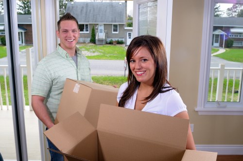 Household moving team handling furniture in a Hammersmith flat move