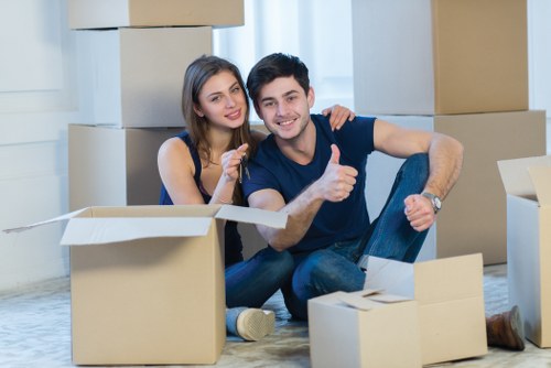 Professional movers carrying furniture into a flat in Hammersmith